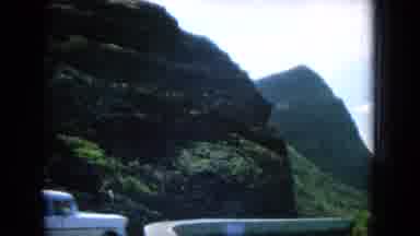 Oahi Hawaii (1964): View Of Abrupt Rocky Yet Green Mountains Bordering Road