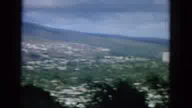 Oahi Hawaii (1964): View Of A Town Below From The Top Of A Hill With People