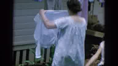 Oahi Hawaii (1964): Lady Hanging Clothes On A Clothesline Outside With Her