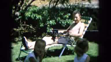 Oahi Hawaii (1964): Man Watching His Young Children Play While Drinking A Beverage