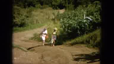Oahi Hawaii (1964): People Walking Up Hill Covered In Foliage Towards Cross