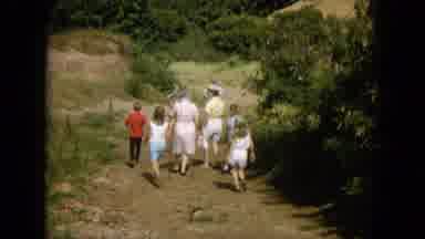 Oahi Hawaii (1964): People Are Walking Down A Village Road With Lot Of Plants On