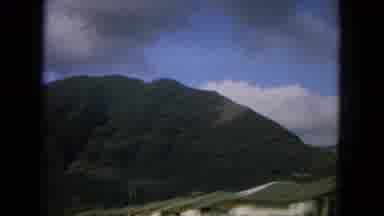 Oahi Hawaii (1964): Moving View Of Tall Green Mountain Near Small Condo Village