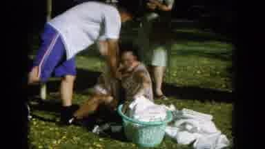 Oahi Hawaii (1964): A Man And Woman Play With A Baby Outside In The Grass