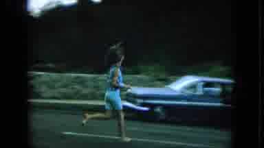 Oahi Hawaii (1964): A Girl Runs Across A Road Followed By A Shot Of A Mountain