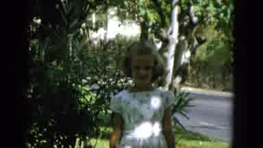 Oahi Hawaii (1964): Young White Blond Girl Waving At Camera In White Dress