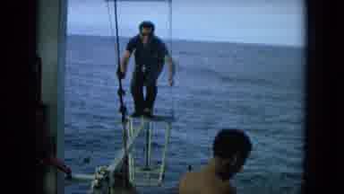 Oahi Hawaii (1964): A Man Climbing A Precarious Part Of A Ship While Wielding A