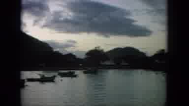 Oahi Hawaii (1964): Boats Are Floating In A Bay Area With Mountains On The Horizon