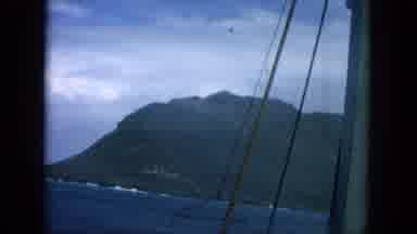 Oahi Hawaii (1964): A Panning Shot From A Boat Of The Sea With Coastal Hills