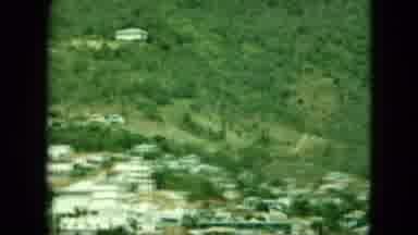Saint Thomas (1964): A Town Set At The Bottom Of A Grassy And Tree Filled Hill