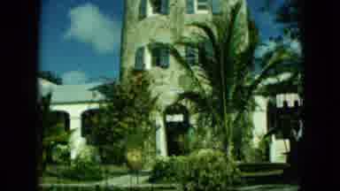 Saint Thomas-1964: Multi Story Stone Building With Tropical Plants And Bright Blue Sky