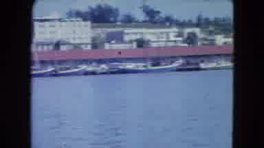 SAN JUAN PUERTO RICO.-1964: Docked Boats In Industrial Marina With Red Roof Buildings