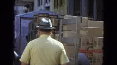 SAN JUAN PUERTO RICO.-1964: Man In Yellow Shirt Walks Through Busy Street With Delivery Truck