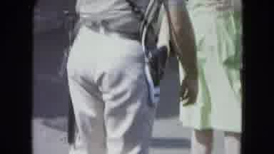 SAN JUAN PUERTO RICO.-1964: Police Officer With Gun Walking Near Classic Car