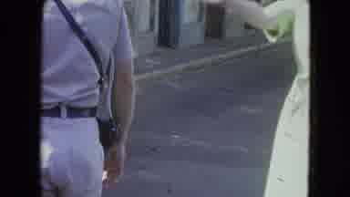SAN JUAN PUERTO RICO.-1964: Man And Woman Waving At Traffic In The Middle Of A
