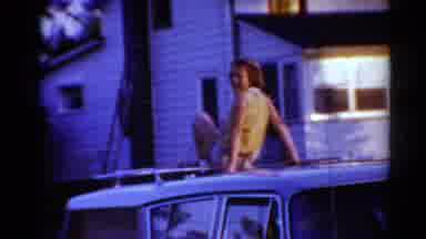 Toledo Ohio (1964): Young Girl Struggles To Climb Down From Car Roof In Front Of