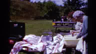 Toledo Ohio (1964): Middle Aged Woman Prepares Food While Older Woman Washes