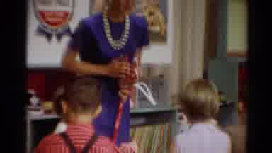 Toledo Ohio (1964): Teacher With Blue Dress And A Necklace Of Pearls Caring Of