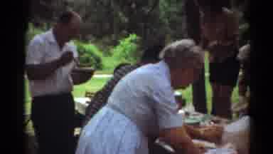 Toledo Ohio (1964): Group Of Older Adults Gathered Outside Having Picnic On Table