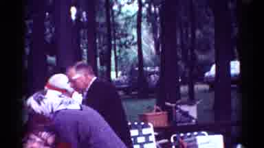 Toledo Ohio (1964): Family Gathering At Picnic Table In Forested Park As Car