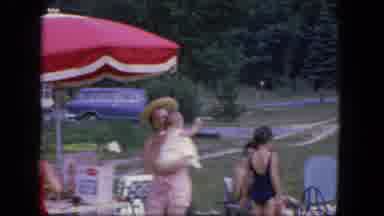 Troy New York (1964): Woman In A Swimsuit And A Hat Holds A Baby Outside While