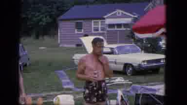 Troy New York (1964): Man In Swim Shorts Snacking While Holding A Drink On A