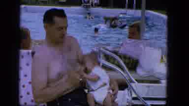 Troy New York (1964): Man Feeds Baby A Bottle At A Pool