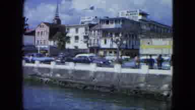 USA Virgin Islands (1964): Cars Passing Along The Side Of A River