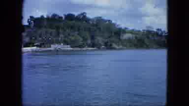 USA Virgin Islands (1964): A Man Standing In Front Of A Large Body Of Water With A