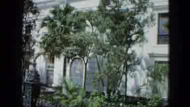 Venezula-1964: White Colonial Building With Arched Windows And Tropical Foliage
