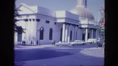 VENEZULA-1964: The Serene City Street With A White Palace And Classic Cars