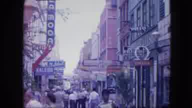 VENEZULA-1964: People Walking Down Busy Street With Vintage Shops And Signage