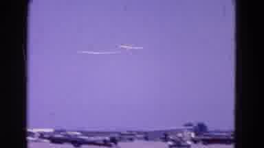 Washington DC (1964): A Single-Engine Airplane Tows A Glider Over An Airport
