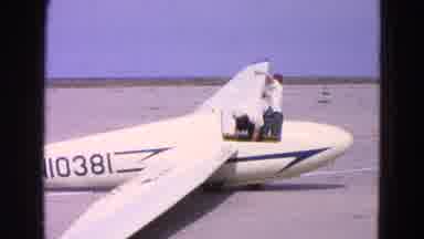 Washington DC-1964: Two Men Inspecting Glider On Airfield
