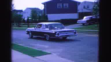 Williamsburg Virginia USA (1964): A Sixties Era Car Drives Down A Neighborhood
