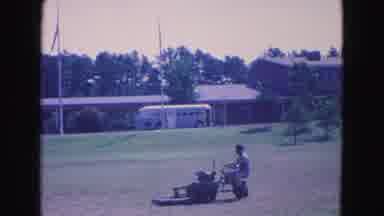 Williamsburg Virginia USA (1964): People Walk Around A Green Park While Man Mows