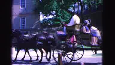 Williamsburg Virginia USA (1964): People Riding In Horse Drawn Carriage Past A