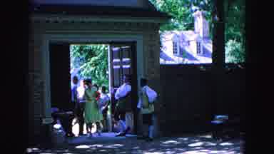 Williamsburg Virginia USA (1964): Man In Costume Leads A Tour Group Through The