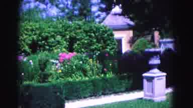 Williamsburg Virginia USA (1964): Woman Walking Past Bench In Daytime And A Garden