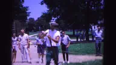 Williamsburg Virginia USA (1964): Man In Hat Prepares A Gun To Be Shot To