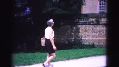 Williamsburg Virginia USA (1964): Woman Walking Down Sidewalk By Brick Wall With
