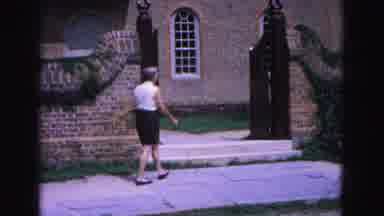 Williamsburg Virginia USA (1964): Woman Walks Past A Sign Towards A Memorial At A