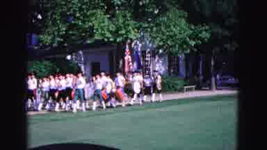 Williamsburg Virginia USA (1964): Marching Band Marches Down The Street Banging