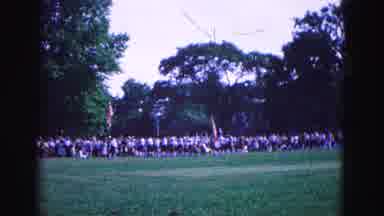 Williamsburg Virginia USA (1964): A Distant Shot Of People Marking And Carrying An