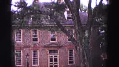 WILLIAMSBURG VIRGINIA USA-1964: Grainy Old Fashioned Victorian Home Under A Tree