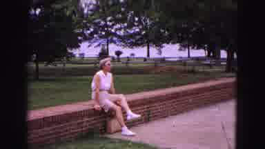 Williamsburg Virginia USA (1964): Woman Sitting On A Brick Wall In Front Of A