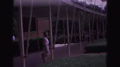 Williamsburg Virginia USA (1964): Woman Stands At Circular Flag Display On A Sunny