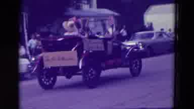 Clarkson Nebraska (1965): Two Vintage Cars Driving Down City Street In Parade