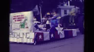 Clarkson Nebraska (1965): Tractor Pulls A Nations Unite Float Through Town In A
