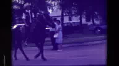 Clarkson Nebraska (1965): Two Men Wearing Cowboy Hats Ride Through The Street On